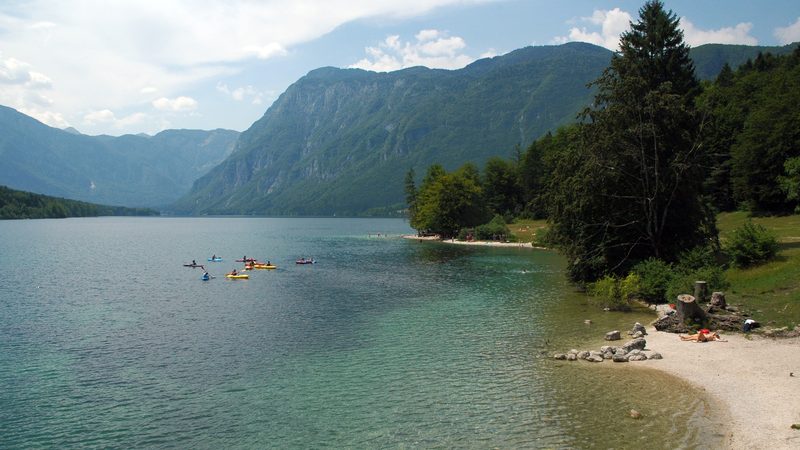 Kayaks and a small beach on Lake Bohinj near Ribčev Laz